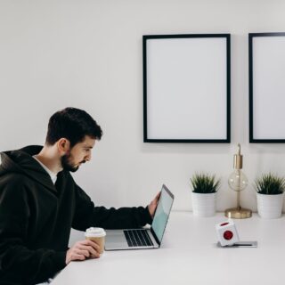 man in black coat sitting at the table