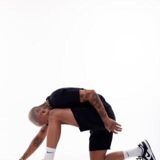 man in sportswear standing on knee in studio