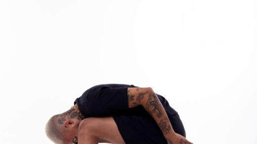 man in sportswear standing on knee in studio