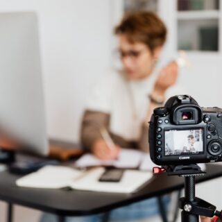 professional photo camera taking photos of anonymous businesswoman