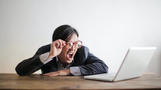 yelling formal man watching news on laptop