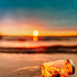 orange mason jar in body of water