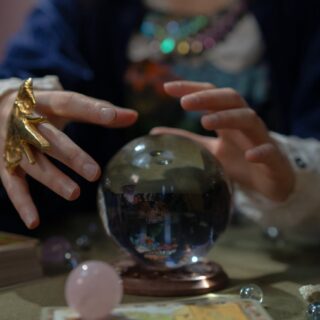 hands over fortune telling crystal ball