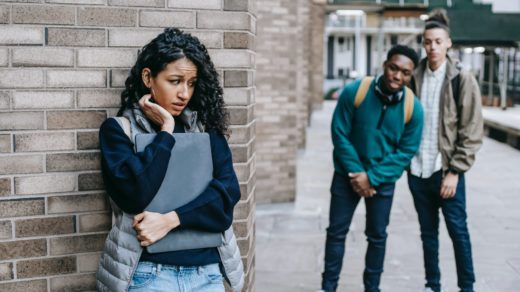 diverse classmates bullying hispanic student in university