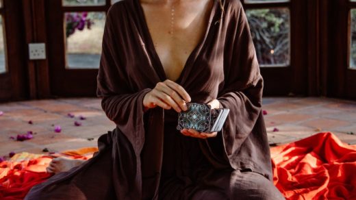 a woman holding a deck of tarot cards