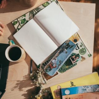 woman at table with empty planner and coffee