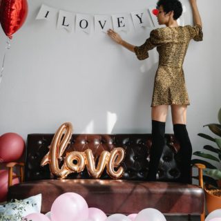 stylish woman decorating lounge for saint valentine day