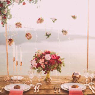 pink and red roses centerpiece near silverwares