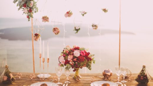 pink and red roses centerpiece near silverwares