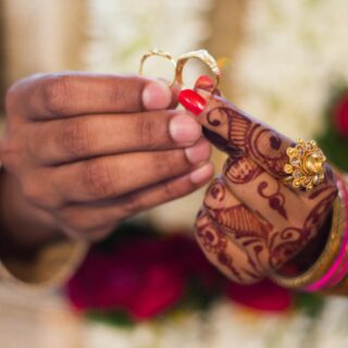 man and woman holding wedding rings