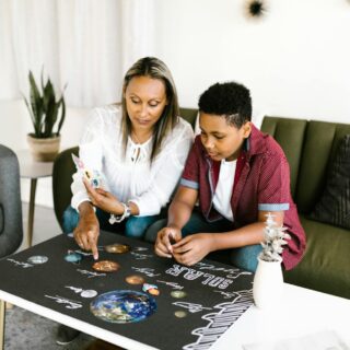 a woman and boy doing school project