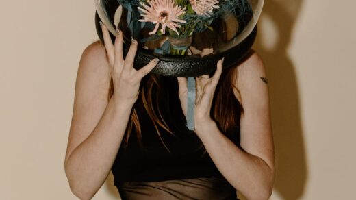woman in black tank top and black skirt holding desk globe