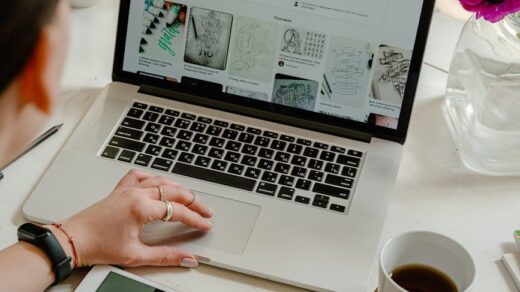 person using macbook pro on table