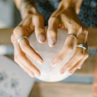 person wearing silver ring holding white ceramic bowl