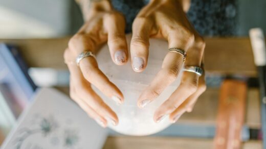 person wearing silver ring holding white ceramic bowl