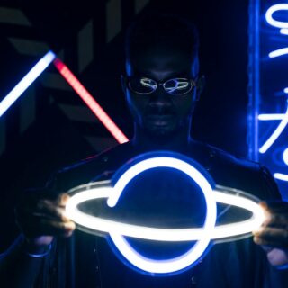a man holding a neon lights