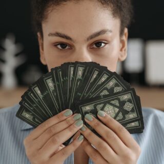 portrait of brunette woman holding tarot cards