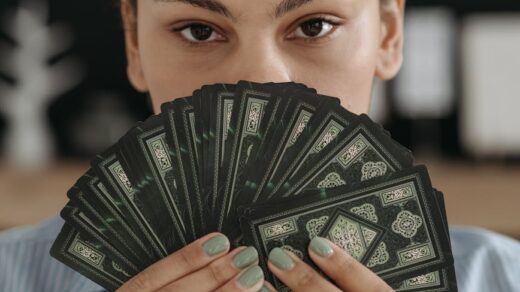 portrait of brunette woman holding tarot cards