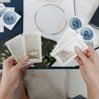 woman holding tarot cards