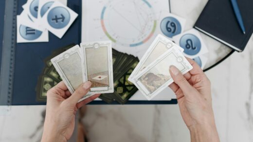 woman holding tarot cards