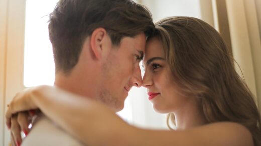 close up photo of hugging couple facing each other while smiling