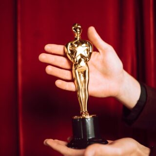 gold trophy on person s hand